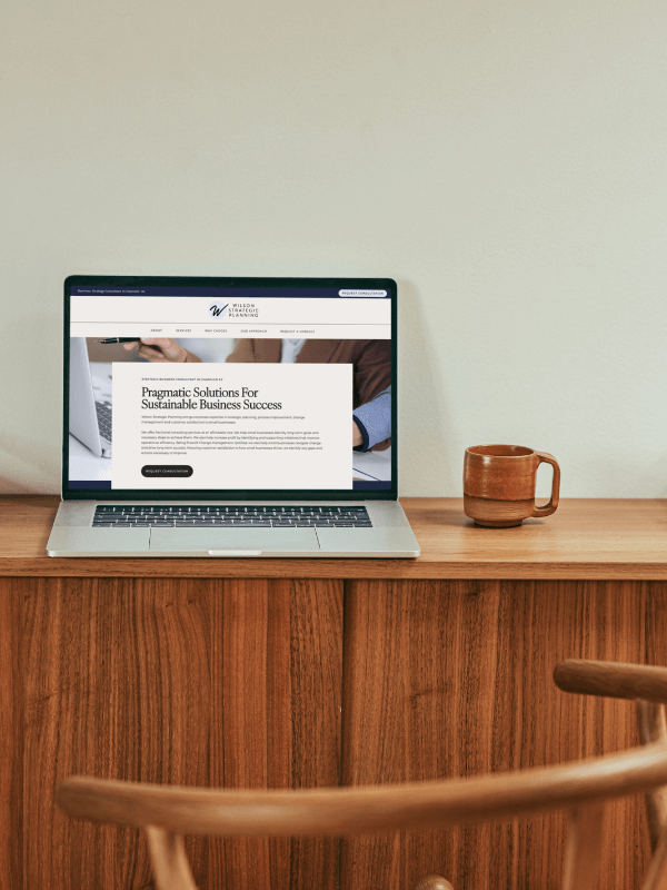 Laptop on a desk displaying Wilson Strategic Planning website homepage – Chandler web design by Sprout Marketing and Design in Chandler, AZ, offering web design and website maintenance services