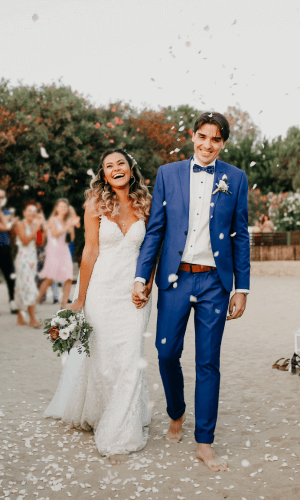 Bride and groom walking hand in hand after the ceremony