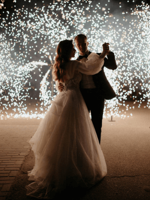Couple sharing a first dance under falling sparklers