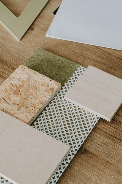 Flooring, tile and fabric samples laid out on a wood table