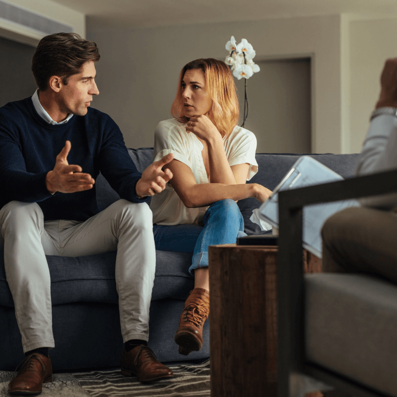 Therapist listening to a client in a bright office