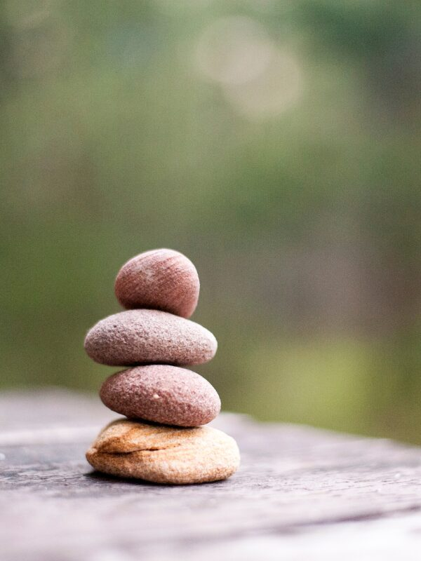 Raked sand and a smooth stone in a small zen garden