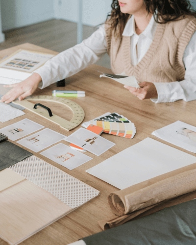 Designer arranging fabric and finish samples on a desk