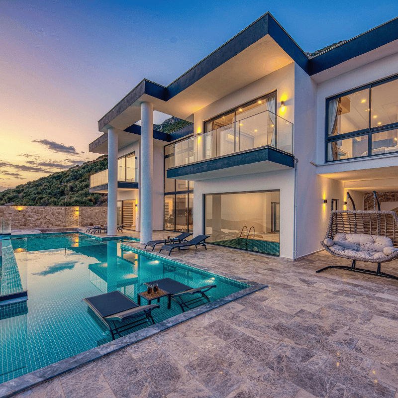 Backyard pool surrounded by desert landscaping