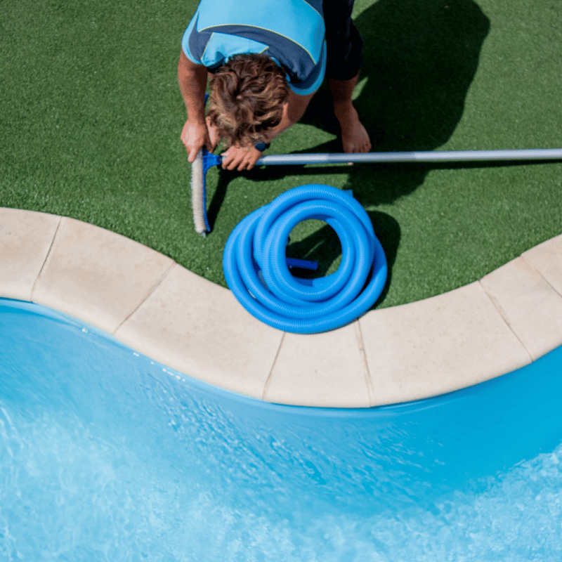 Pool technician working on a backyard pool