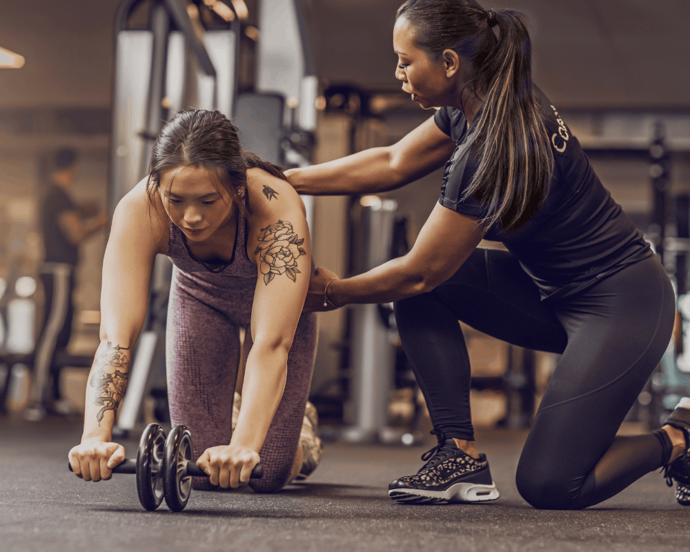 Client working one-on-one with a personal trainer