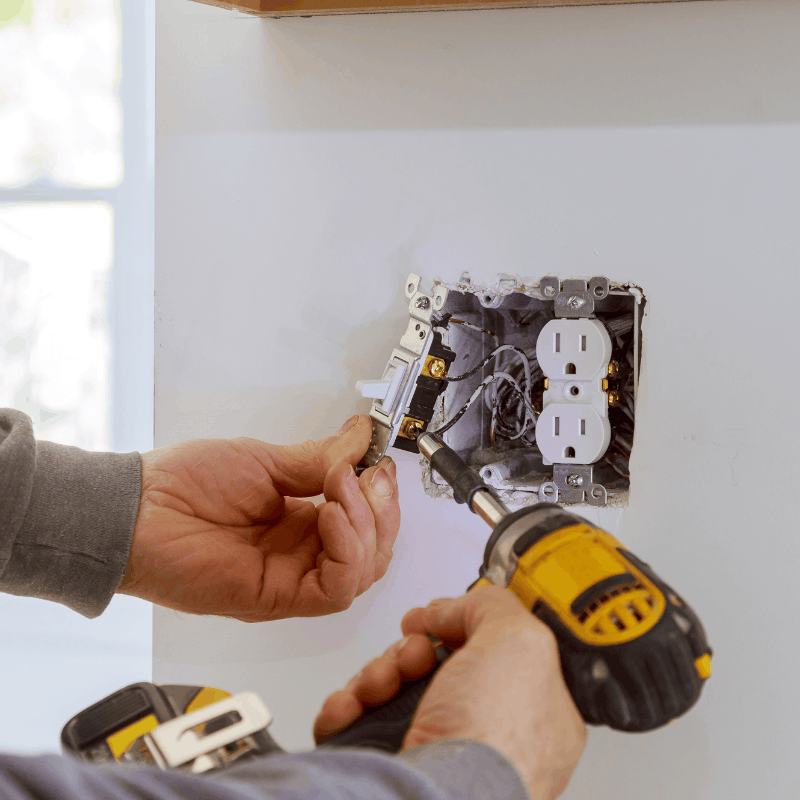 Electrician wiring a new outlet