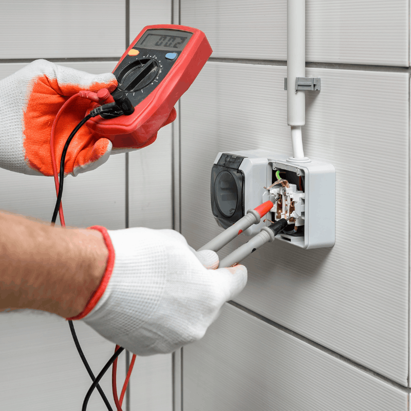 Electrician testing a circuit with a meter