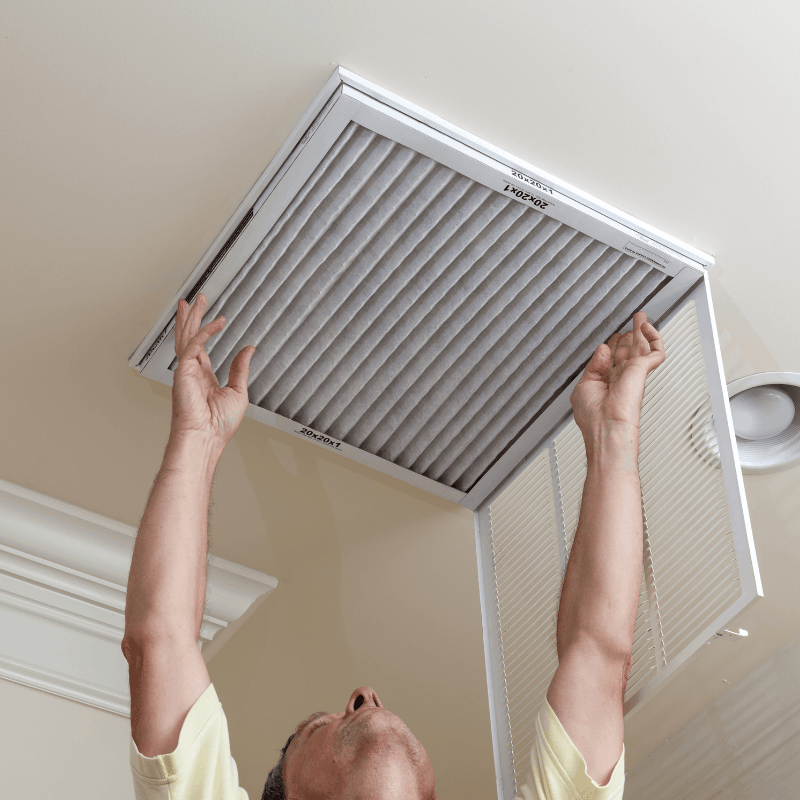 Technician changing a home air filter