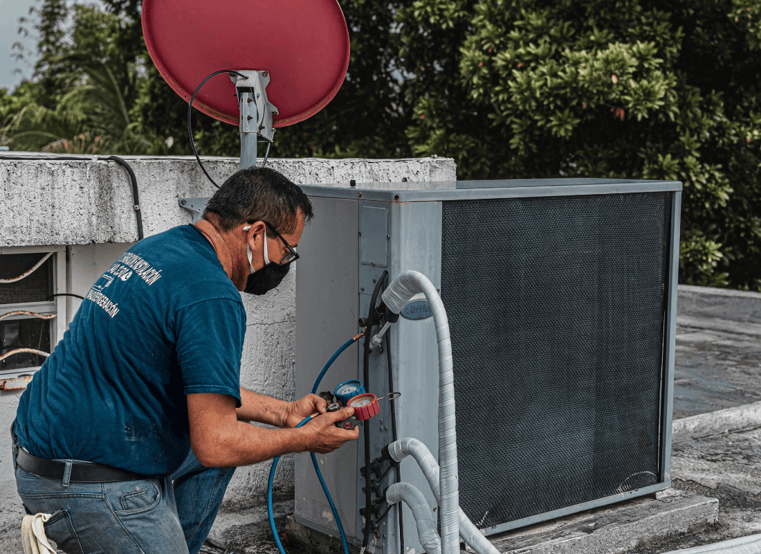 Technician repairing an outdoor AC condenser