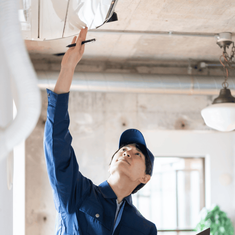 Technician testing airflow at a supply vent