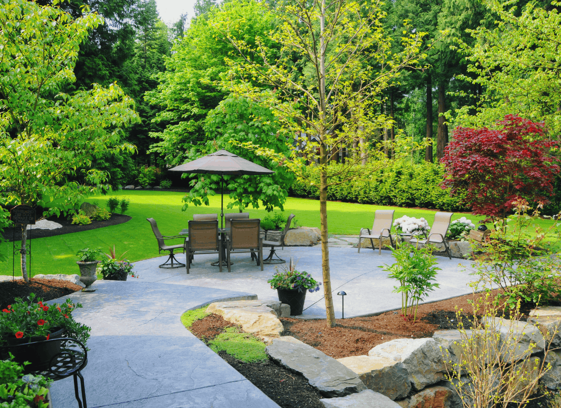 Landscaped garden with lush green grass and carefully planted beds