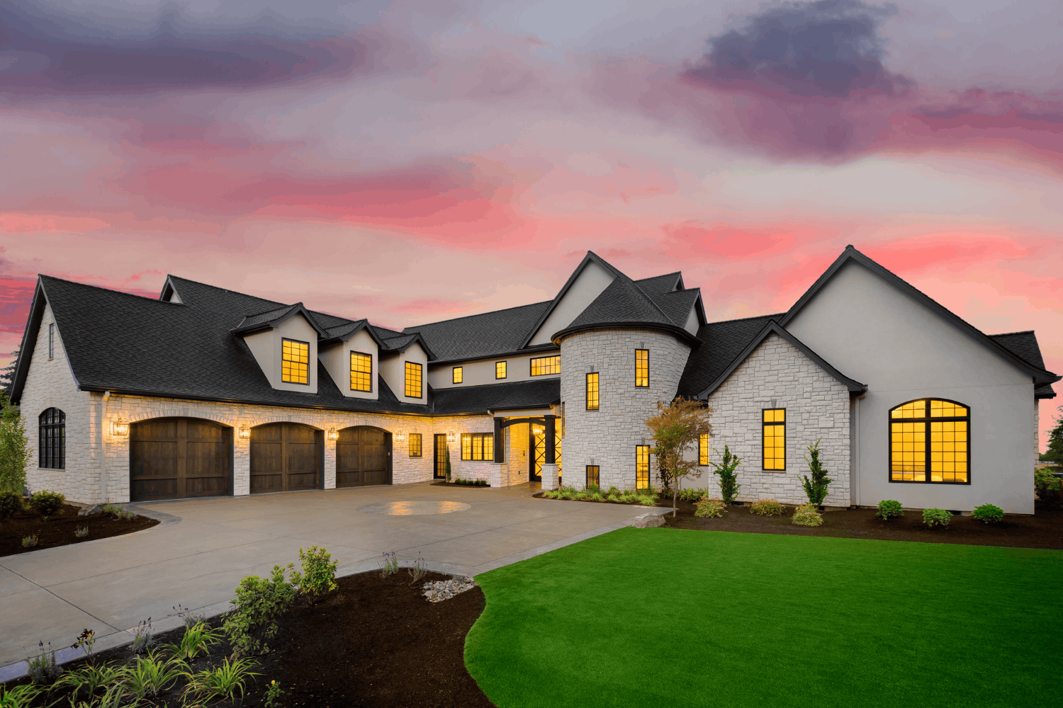 Custom luxury home outside Reno lit up at sunset