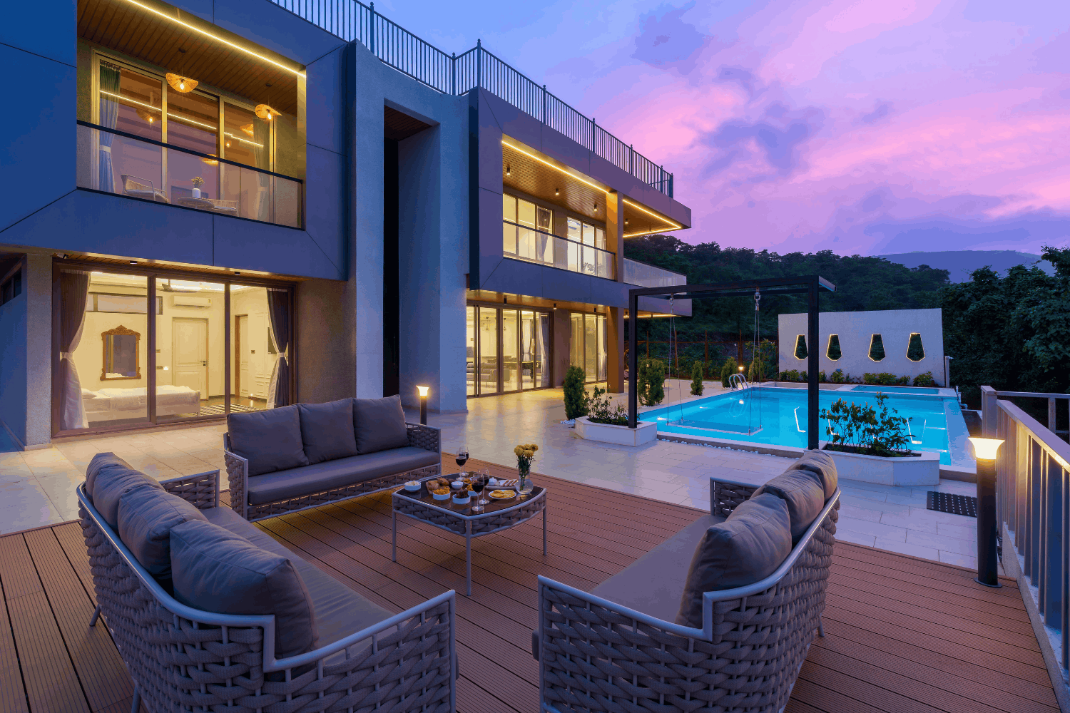 Outdoor living space and pool behind a custom home
