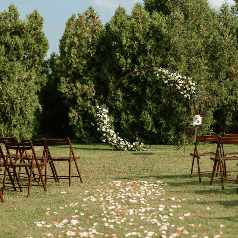 Outdoor wedding ceremony with guests seated in rows