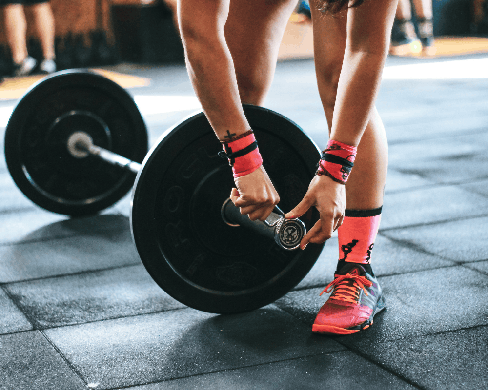 Weights being loaded onto a barbell