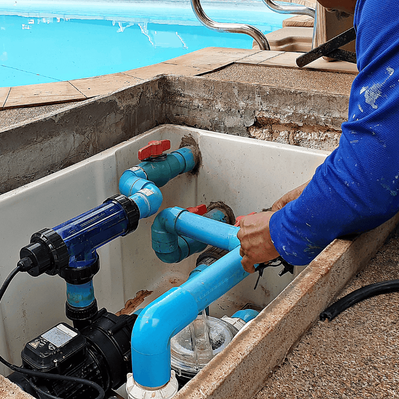 Pool technician making a repair on pool equipment