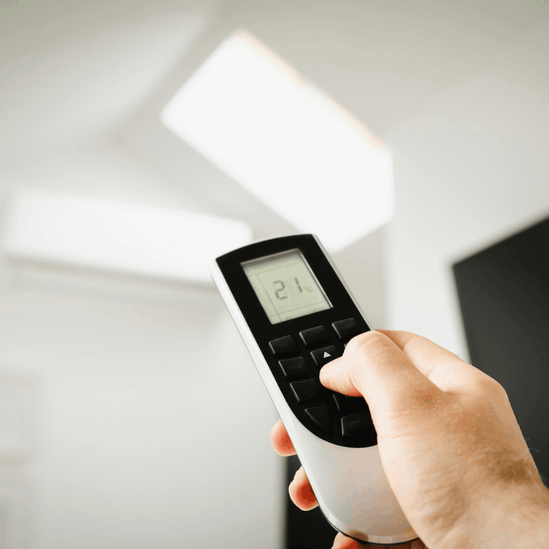 Homeowner adjusting a smart thermostat
