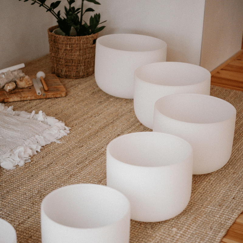 Singing bowls arranged on the studio floor