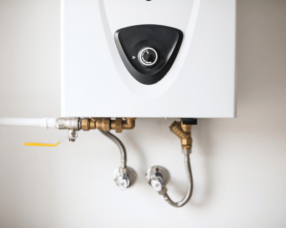 Tankless water heater installed on a garage wall