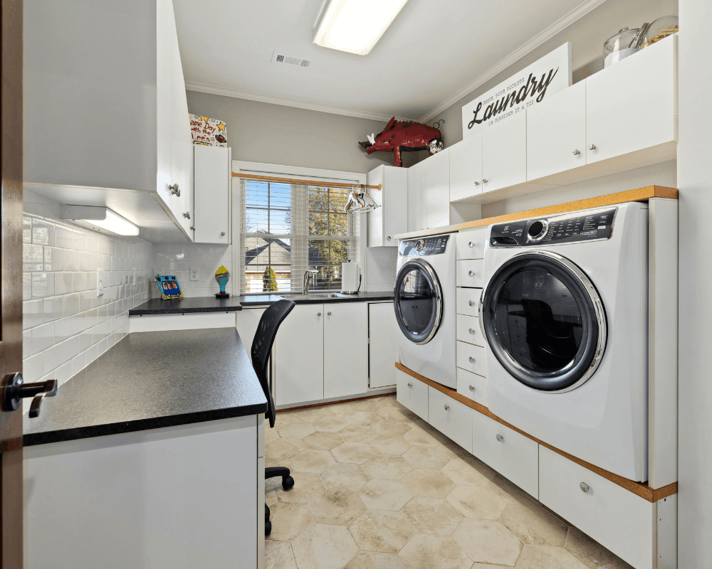 Plumber connecting a washer in a laundry room