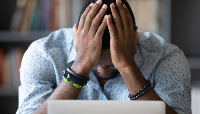 Frustrated person with hands on head, illustrating the impact of an outdated web design on business growth, featured on Sprout Marketing and Design’s blog
