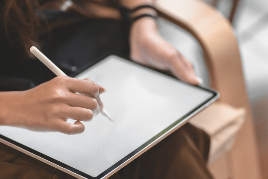 Woman using a tablet to view logo design concepts, featured on Sprout Marketing and Design’s logo design services in Chandler, AZ.